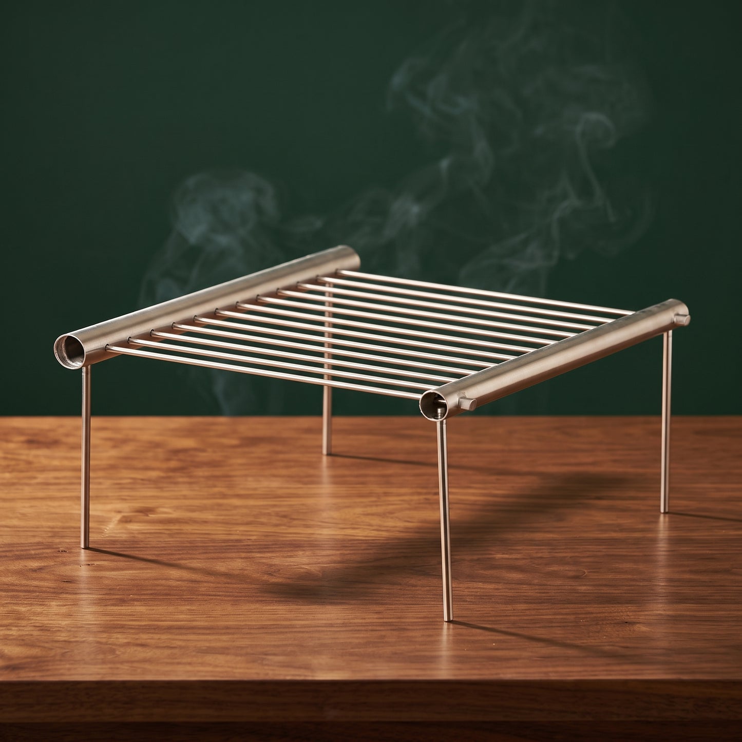 The Scout pack-down portable grill on a walnut table, Big Ron BBQ catalog