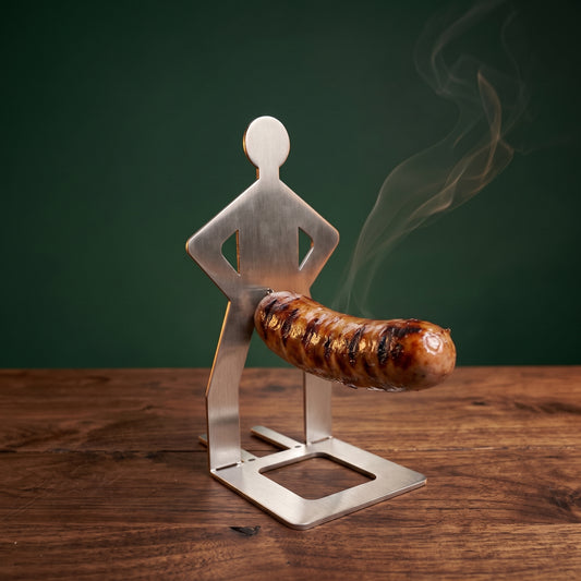 Big Ron stainless steel sausage holder with a grilled bratwurst on his hook, walnut table