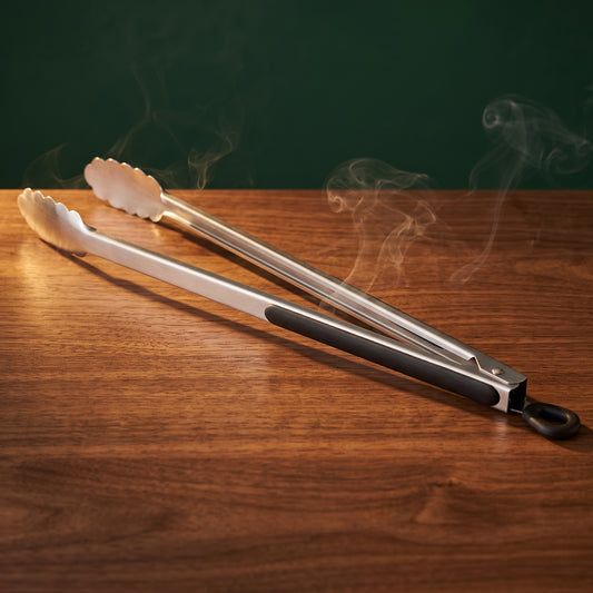 Long Arm locking grill tongs on a walnut table, Big Ron BBQ catalog