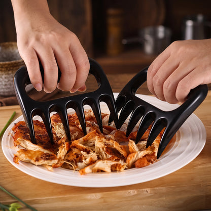 Bear claw meat shredders pulling apart cooked chicken